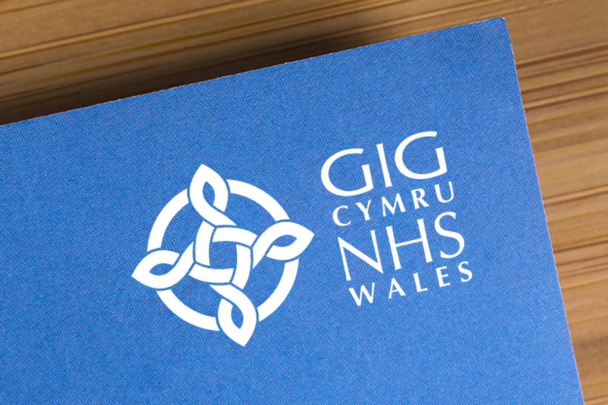 NHS Wales Logo on Blue Paper