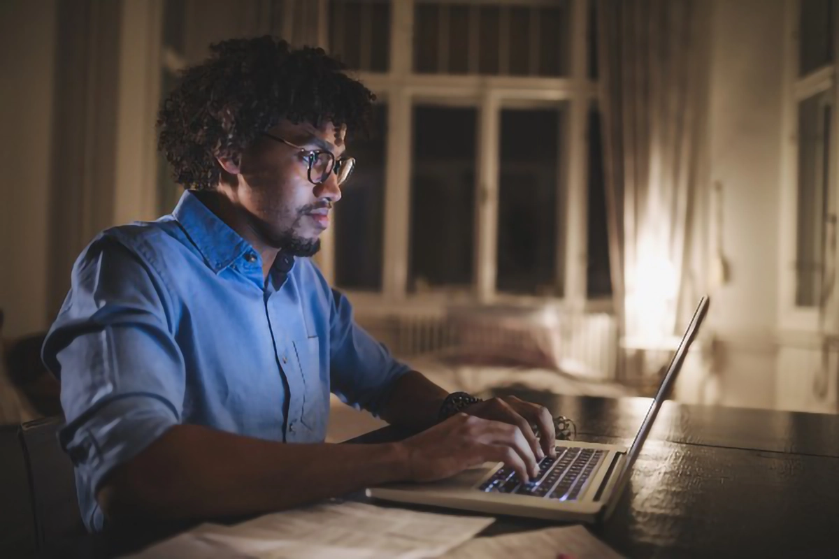 Man on sofa at night accessing Welsh GP Records